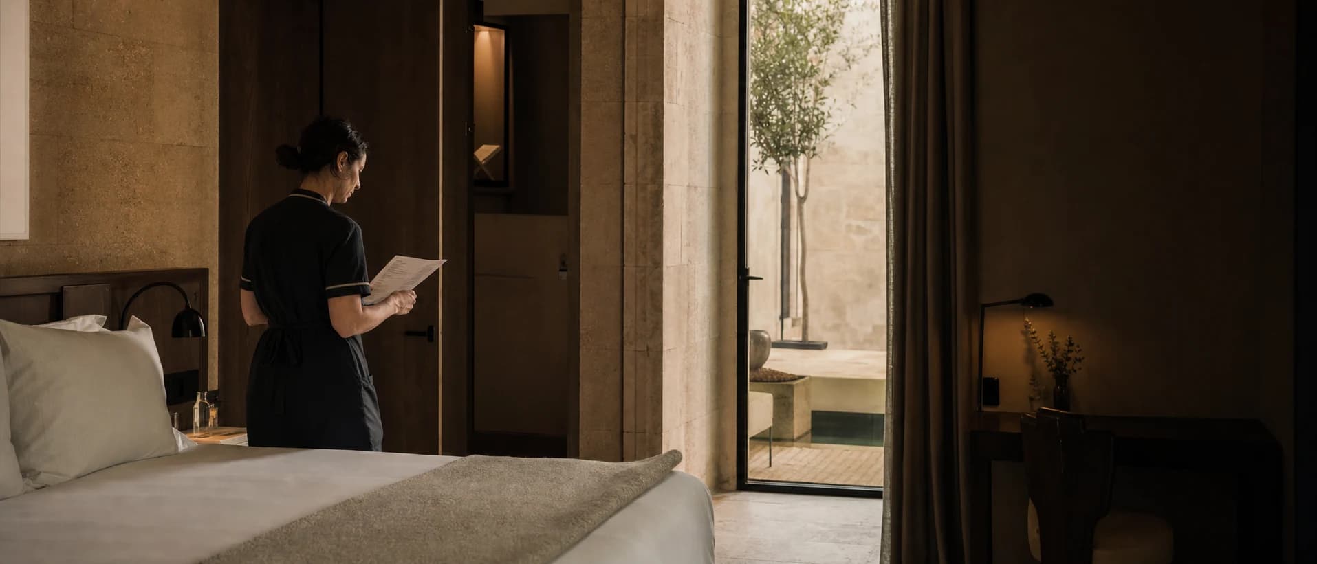 Supervisor checks a prepared hotel room before the guest arrives.